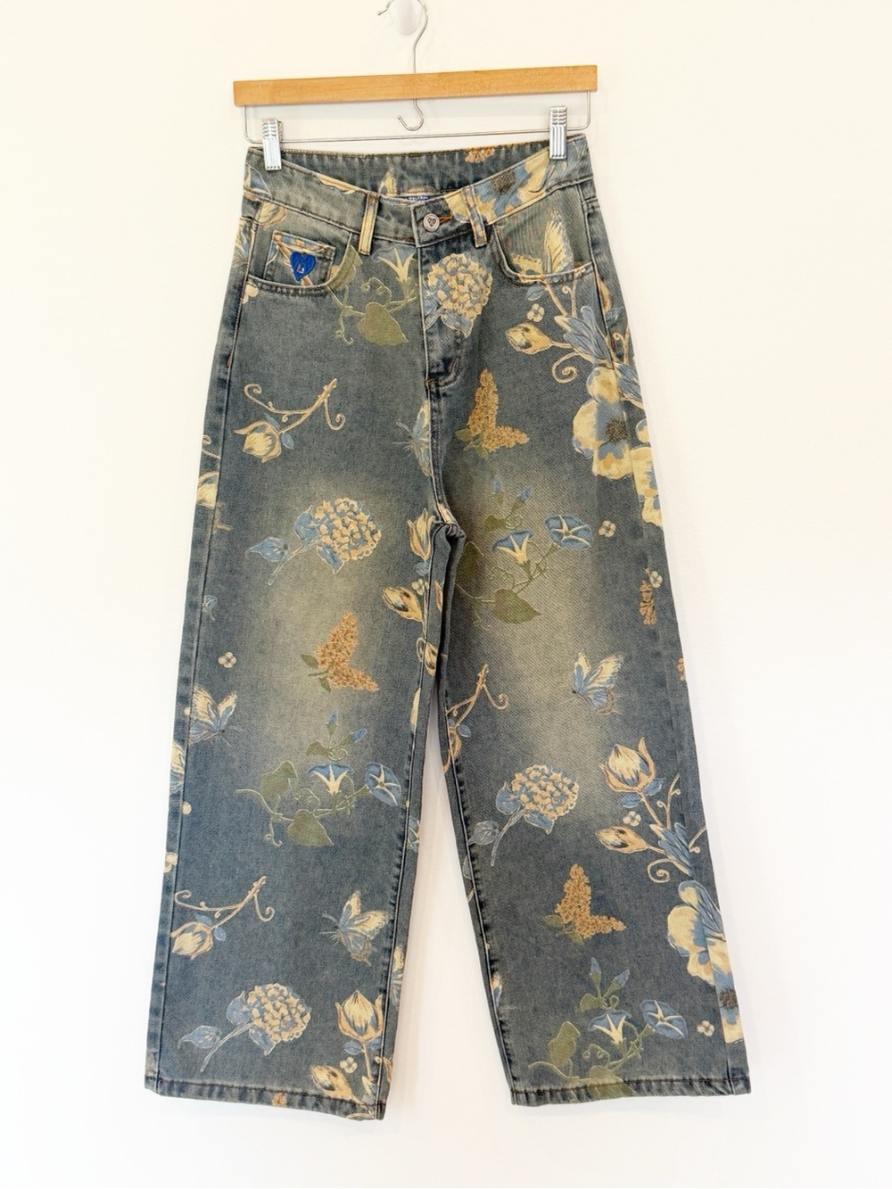 Delfric Eden floral and butterfly print jeans with blue yellow and green flowers